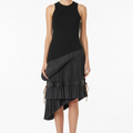 Black sleeveless dress with pleated skirt on a mannequin against a gray background