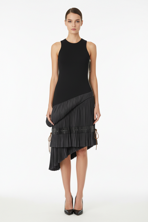 Black sleeveless dress with pleated skirt on a mannequin against a gray background
