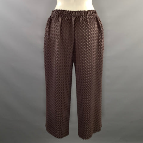 Back view of elastic-waist brown chevron-pleated pants.