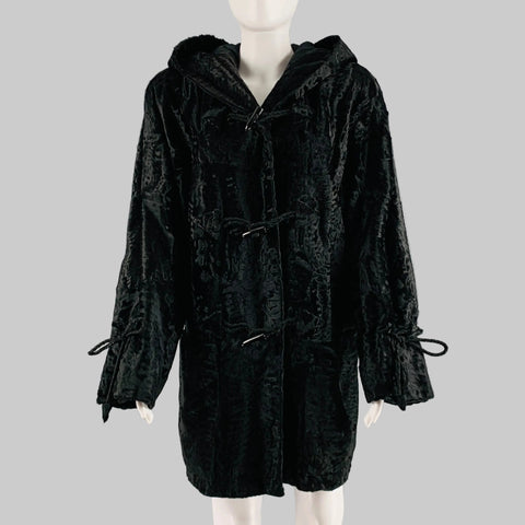 Black textured coat on a mannequin against a gray background