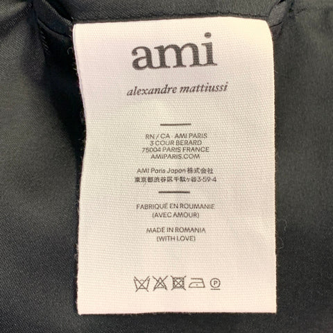 Costume AMI by ALEXANDRE MATTIUSSI en laine verte à revers crantés, taille 38