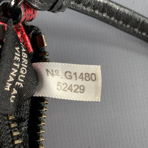 Portefeuille COACH zippé rouge et noir avec dragonne