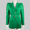 A green polyester wool twill GIVENCHY single breasted belted jacket with a pleated waist and dramatic padded shoulders, displayed on a mannequin.