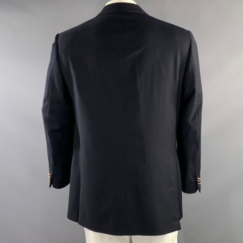 Back view of navy sport coat showing center back seam and double vents.