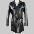 A double-breasted, belt-cuffed VALENTINO navy lambskin leather trench coat with a pointed collar and a waist belt, featuring a blue and black virgin wool blend herringbone lining.
