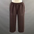 Front close view of elastic waistband and upper legs of brown chevron-pleated pants.