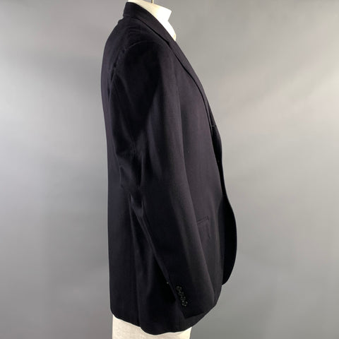 Side view of the black sport coat showing the notch lapel, sleeve, and cuff buttons.