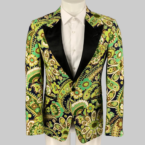 Patterned blazer with black lapels on a mannequin against a gray background
