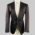 Patterned black jacket on a mannequin against a gray background