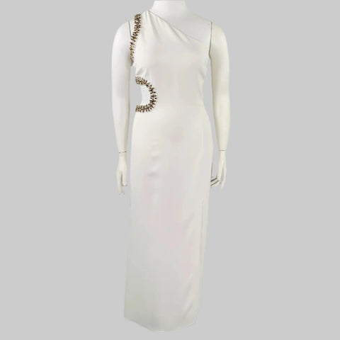 White dress with embellishments on a mannequin against a gray background