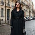 Black trench coat on a mannequin against a gray background