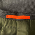 Interior close-up showing orange Isaia neck label and dark lining.