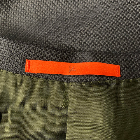 Interior close-up showing orange Isaia neck label and dark lining.