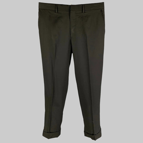 Black wool cuffed dress pants with a front tab and zip fly closure, displayed on a plain background.