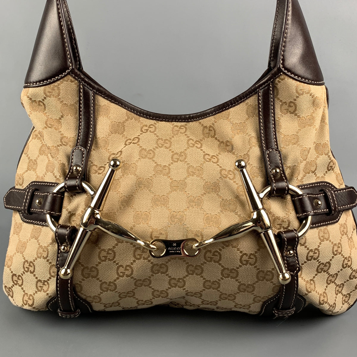 Sui Generis archive reference view of a Gucci beige and brown monogram canvas and leather 85th Anniversary hobo handbag, SKU 110845.