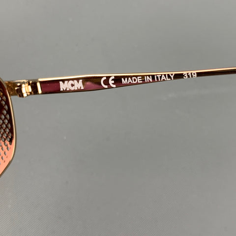 Lunettes de soleil en métal rose doré MCM