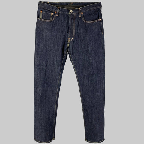 A pair of RRL by RALPH LAUREN indigo cotton jeans with a straight leg and contrast stitching, displayed on a plain background.