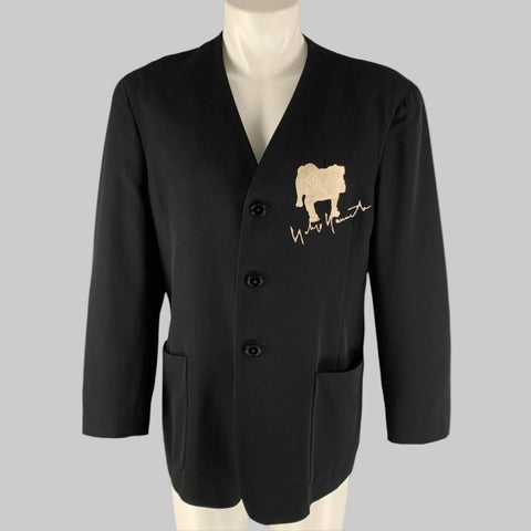 Black blazer with a logo on a mannequin against a gray background