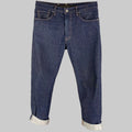 A pair of LEVI'S 551 Z indigo cotton straight jeans with contrast stitching and a button fly, displayed on a hanger.