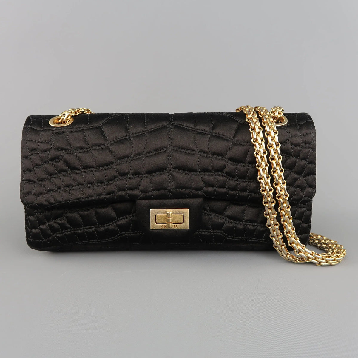 Sui Generis product photograph of a black Chanel 2.55 Reissue-style shoulder bag with quilted body, all-metal chain and rectangular Mademoiselle-style turnlock