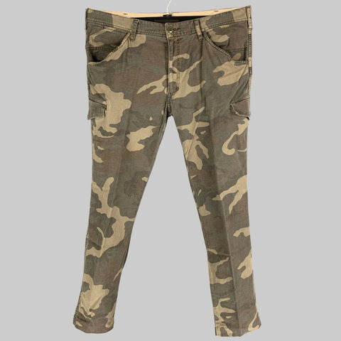 Pair of olive taupe camouflage cargo casual pants with slim fit and zip fly closure, displayed on a hanger.