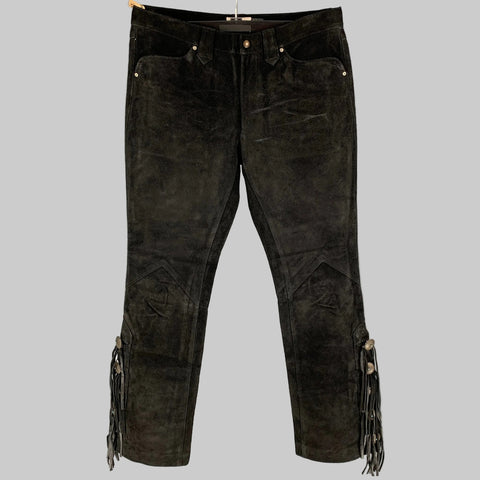 Black distressed suede western fringe pants with a zip fly closure, displayed on a hanger.