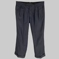 A pair of indigo pleated casual pants for men, displayed on a hanger against a white background.