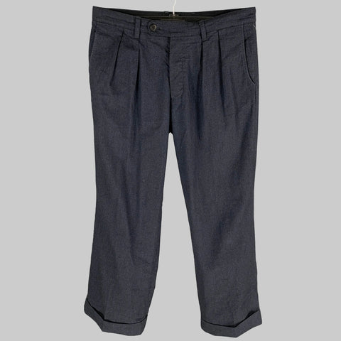 A pair of indigo pleated casual pants for men, displayed on a hanger against a white background.