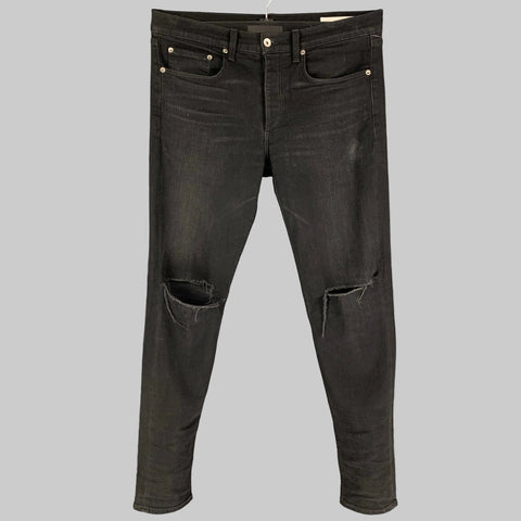 Black distressed slim button fly jeans with cotton and polyurethane fabric.