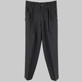 Black pleated wool high waisted dress pants by GIANNI VERSACE, displayed on a mannequin against a white background.